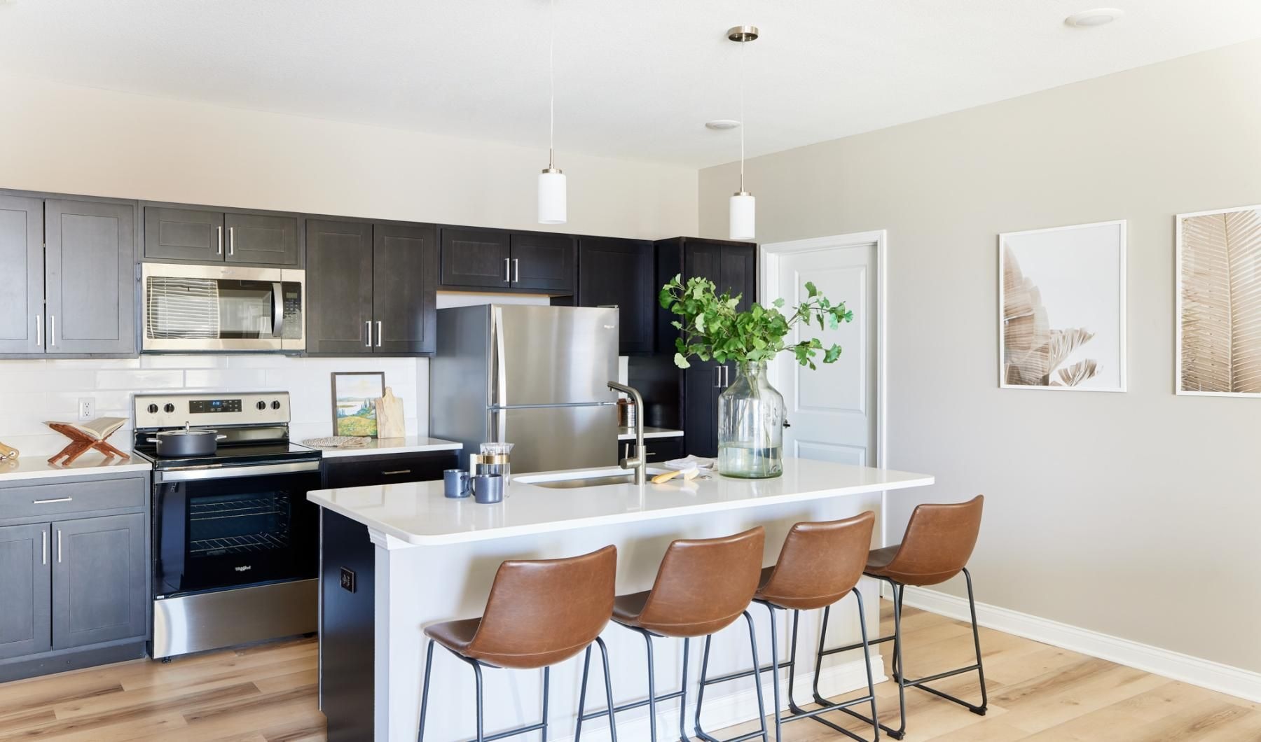 Beautiful kitchens with designer finishes a kitchen with a table and chairs