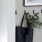 a black purse hanging on a wall