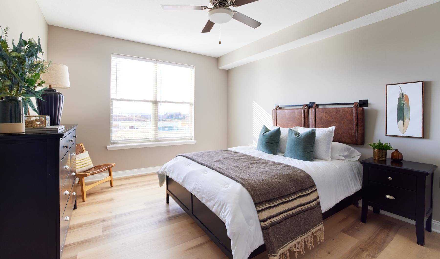 Generous bedroom offerings to fit every family a bedroom with a bed and a fan